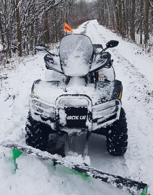 ATV with snowplough on the trails